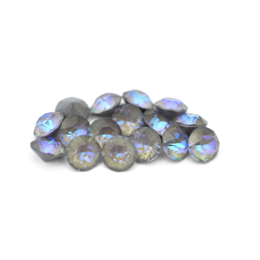 Round faceted Austrian crystal rhinestones in the color Serene Gray Delite displayed on a white background