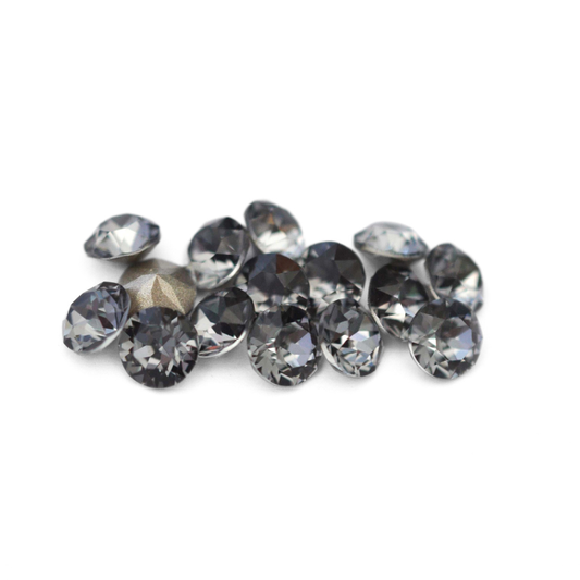Round faceted Austrian crystal rhinestones in the color Silver Night displayed on a white background