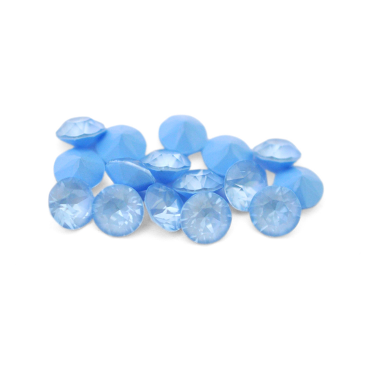 Round faceted Austrian crystal rhinestones in the color Sky Ignite displayed on a white background