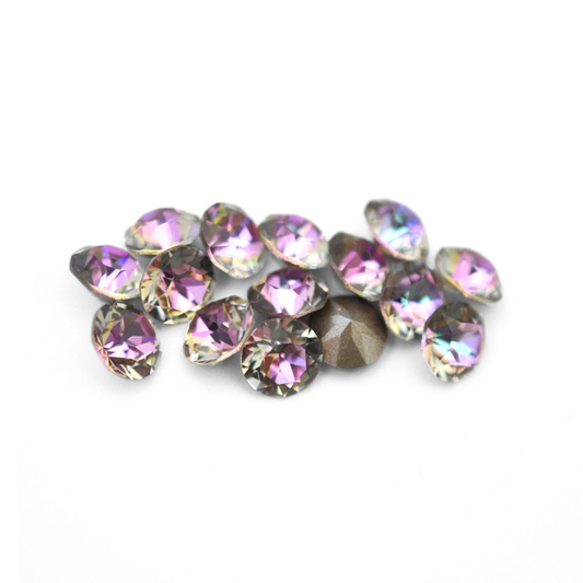 Round faceted Austrian crystal rhinestones in the color Vitrail Light displayed on a white background
