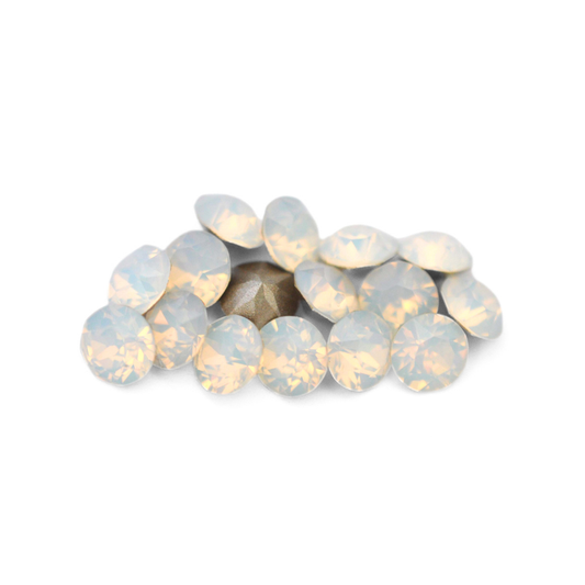 Round faceted Austrian crystal rhinestones in the color White Opal displayed on a white background