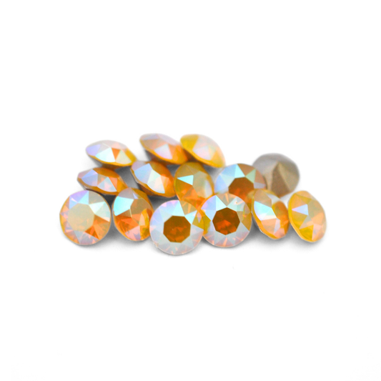 Round faceted Austrian crystal rhinestones in the color Yellow Opal Shimmer displayed on a white background