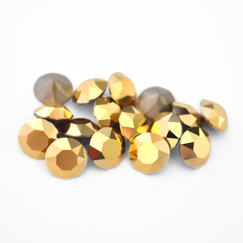 Round faceted Austrian crystal rhinestones in the color Aurum displayed on a white background