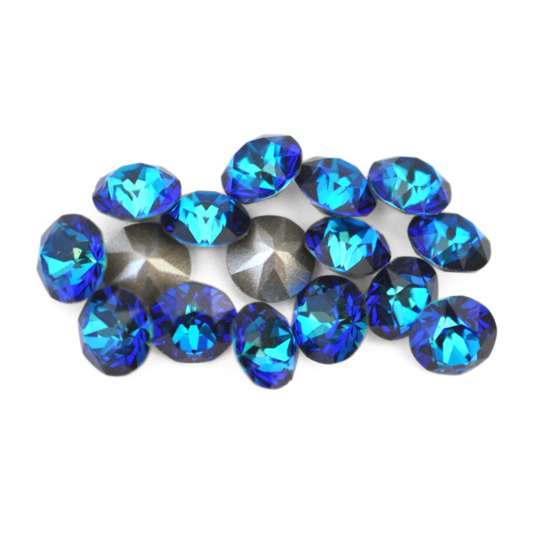 Round faceted Austrian crystal rhinestones in the color Bermuda Blue displayed on a white background.