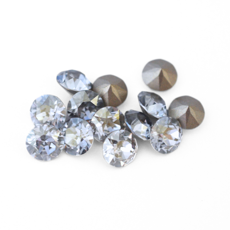 Round faceted Austrian crystal rhinestones in the color Blue Shade displayed on a white background