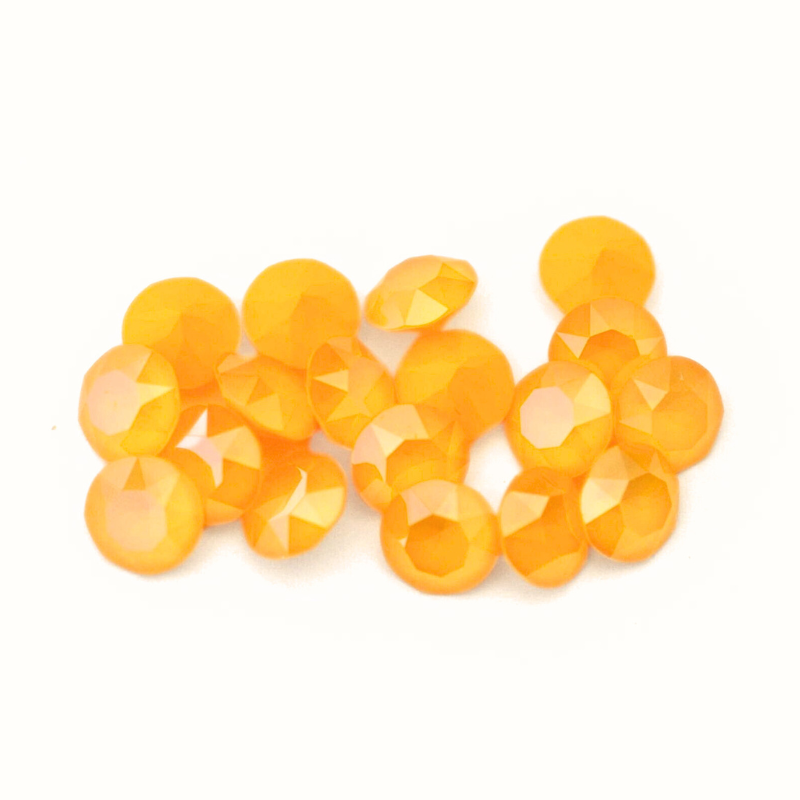 Round faceted Austrian crystal rhinestones in the color Buttercup displayed on a white background.