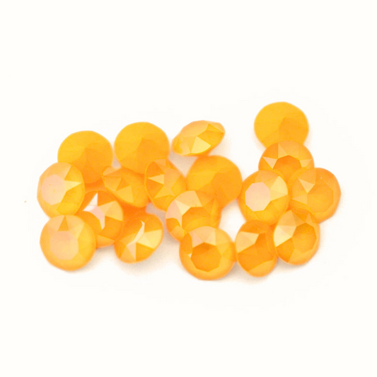 Round faceted Austrian crystal rhinestones in the color Buttercup displayed on a white background.