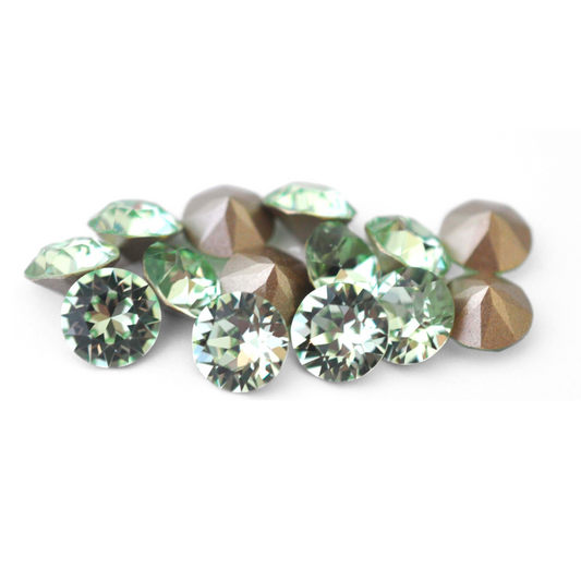 Round faceted Austrian crystal rhinestones in the color Chrysolite displayed on a white background.