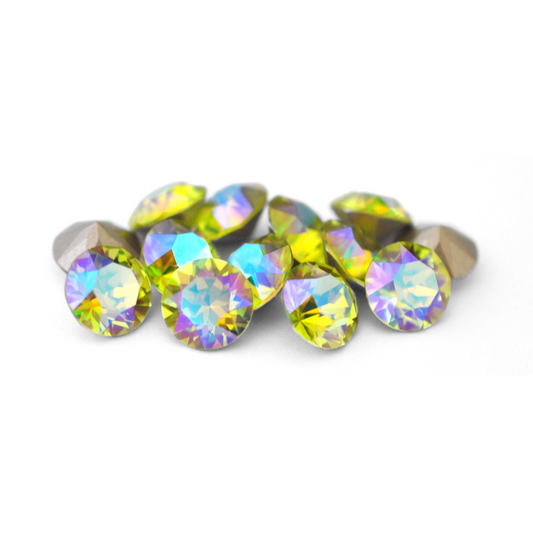 Round faceted Austrian crystal rhinestones in the color Citrus Green Blue AB displayed on a white background.