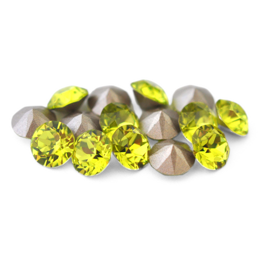 Round faceted Austrian crystal rhinestones in the color Citrus Green displayed on a white background.