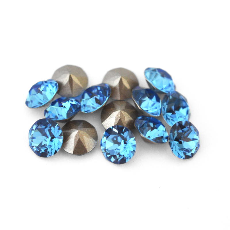 Round faceted Austrian crystal rhinestones in the color Cool Blue displayed on a white background