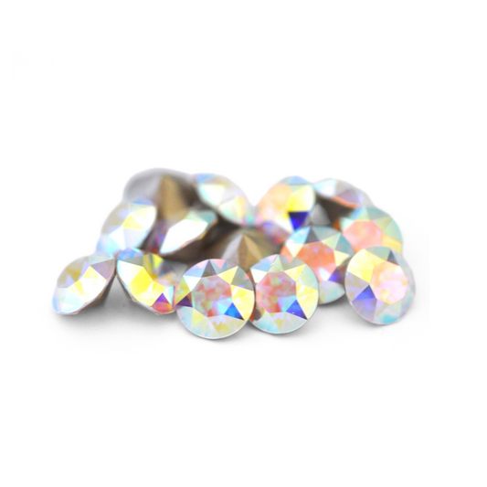 Round faceted Austrian crystal rhinestones in the color Crystal AB displayed on a white background.