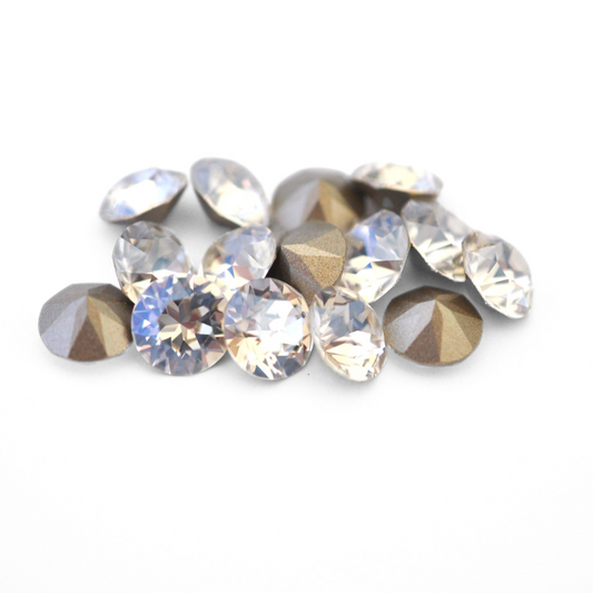 Round faceted Austrian crystal rhinestones in the color Crystal Glitz displayed on a white background.