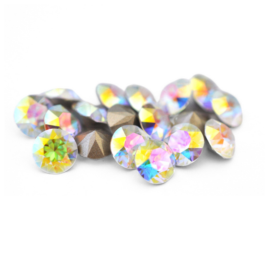 Round faceted Austrian crystal rhinestones in the color Crystal Transmission displayed on a white background.
