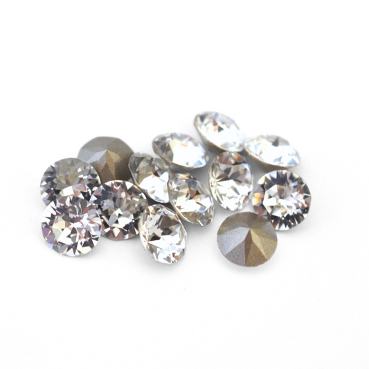 Round faceted Austrian crystal rhinestones in the color Crystal displayed on a white background.