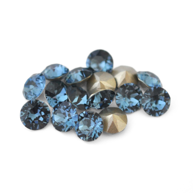 Round faceted Austrian crystal rhinestones in the color Denim Blue displayed on a white background