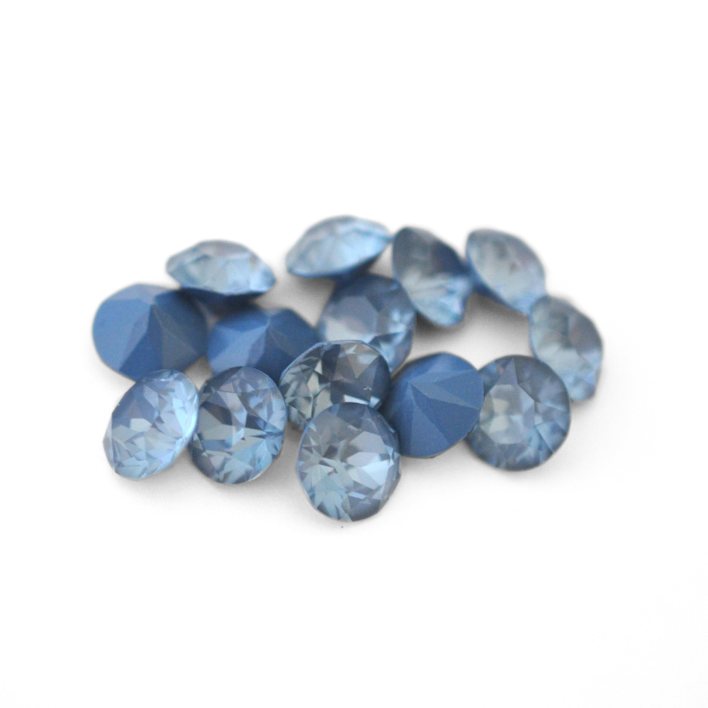 Round faceted Austrian crystal rhinestones in the color Denim Ignite displayed on a white background