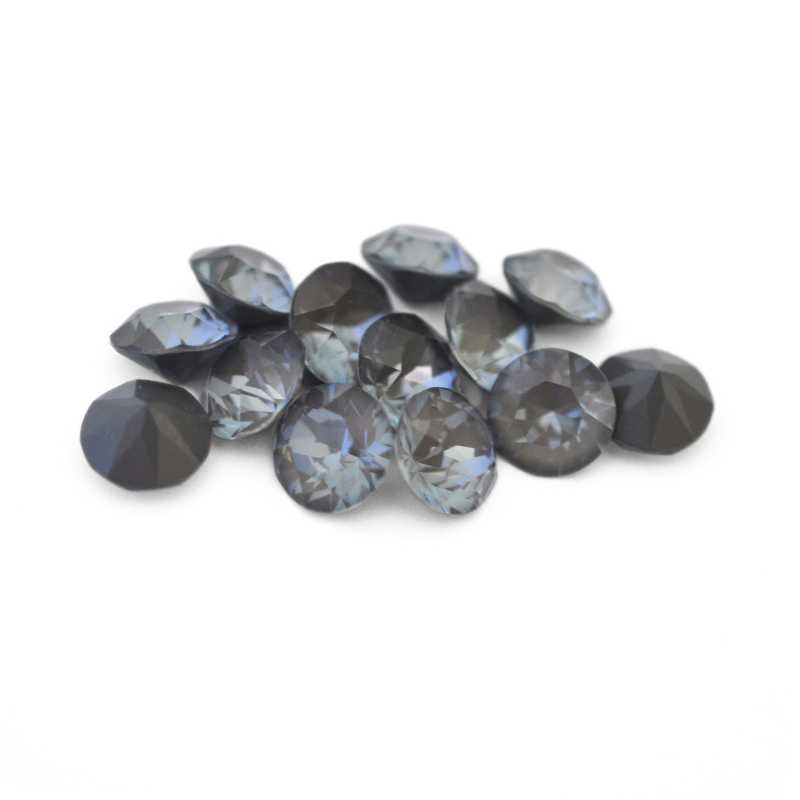Round faceted Austrian crystal rhinestones in the color Dark Grey Ignite displayed on a white background.