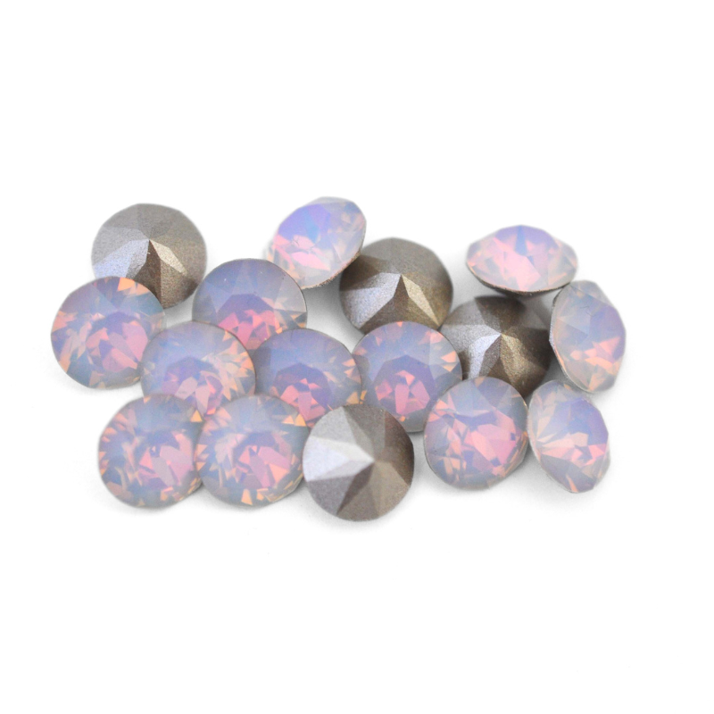 Round faceted Austrian crystal rhinestones in the color Dreamy Vitrail displayed on a white background.