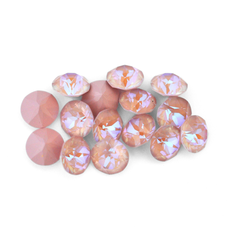 Round faceted Austrian crystal rhinestones in the color Dusty Pink Delite displayed on a white background.