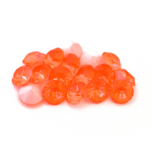 Round faceted Austrian crystal rhinestones in the color Electric Orange Ignite displayed on a white background.