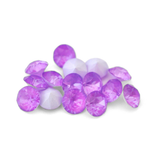 Round faceted Austrian crystal rhinestones in the color Electric Violet Ignite displayed on a white background.