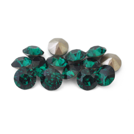 Round faceted Austrian crystal rhinestones in the color Emerald displayed on a white background.