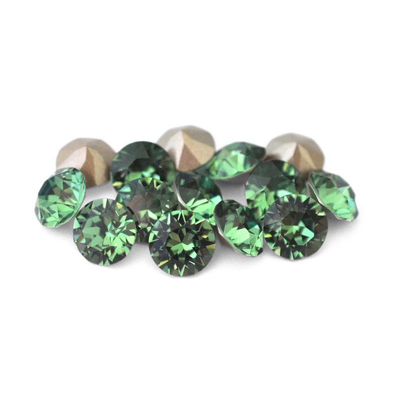 Round faceted Austrian crystal rhinestones in the color Erinite displayed on a white background.