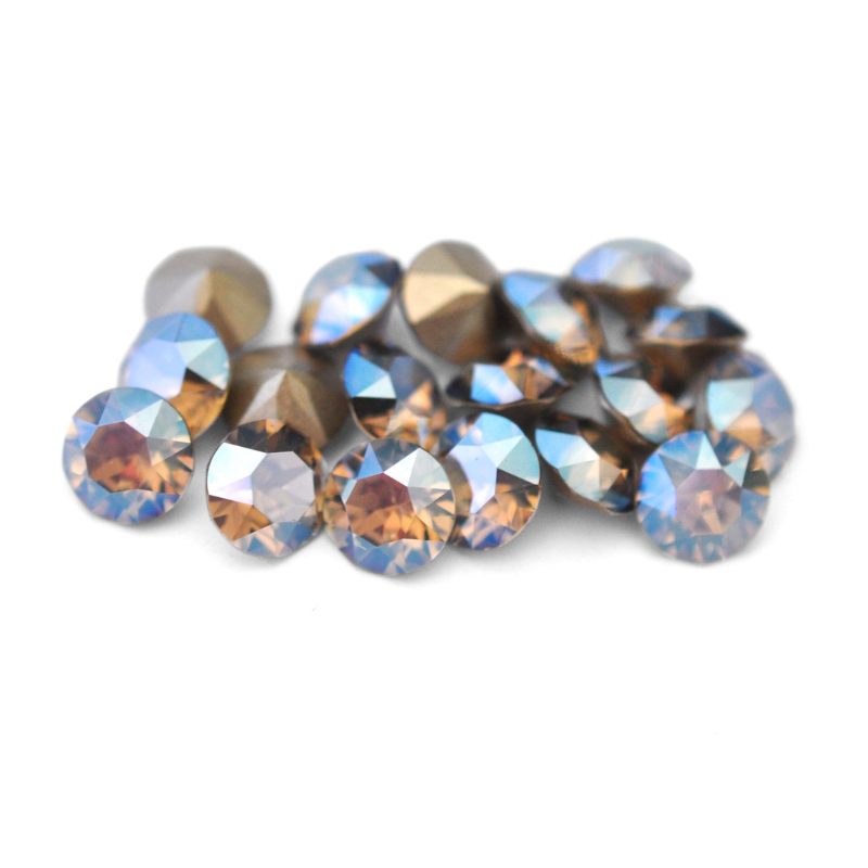 Round faceted Austrian crystal rhinestones in the color Greige Moonlight displayed on a white background