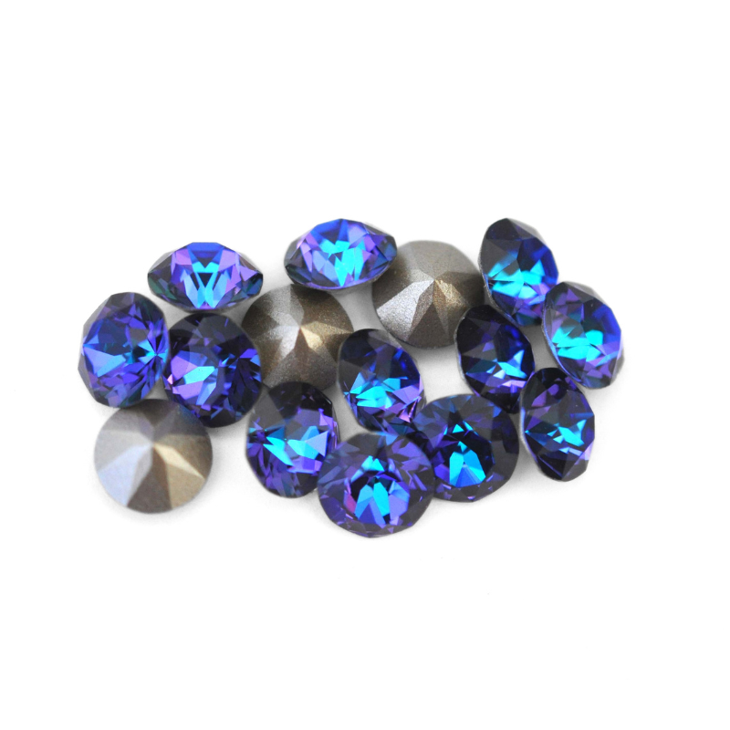 Round faceted Austrian crystal rhinestones in the color Heliotrope displayed on a white background.