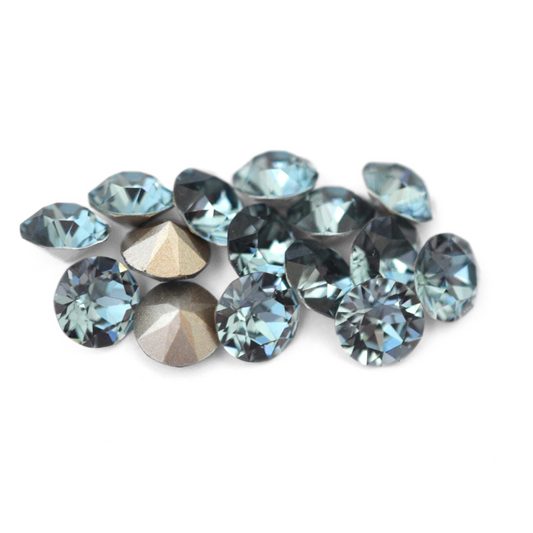 Round faceted Austrian crystal rhinestones in the color Indian Sapphire displayed on a white background