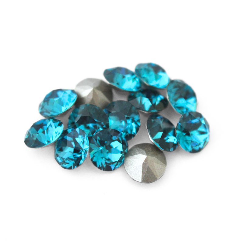 Round faceted Austrian crystal rhinestones in the color Indicolite displayed on a white background
