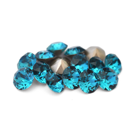 Round faceted Austrian crystal rhinestones in the color Indicolite displayed on a white background