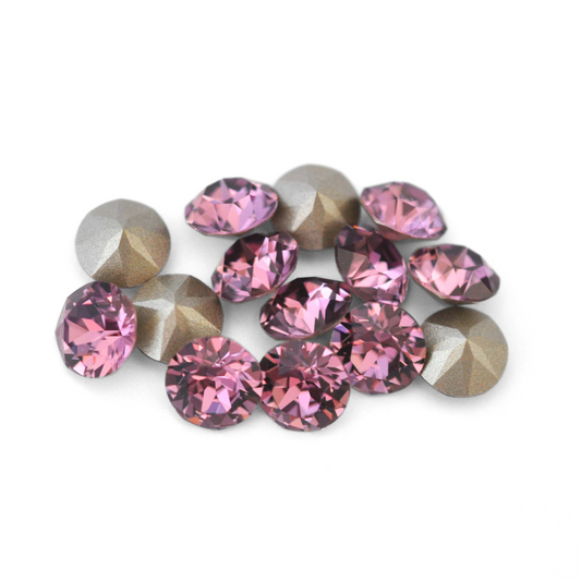 Round faceted Austrian crystal rhinestones in the color Iris displayed on a white background.