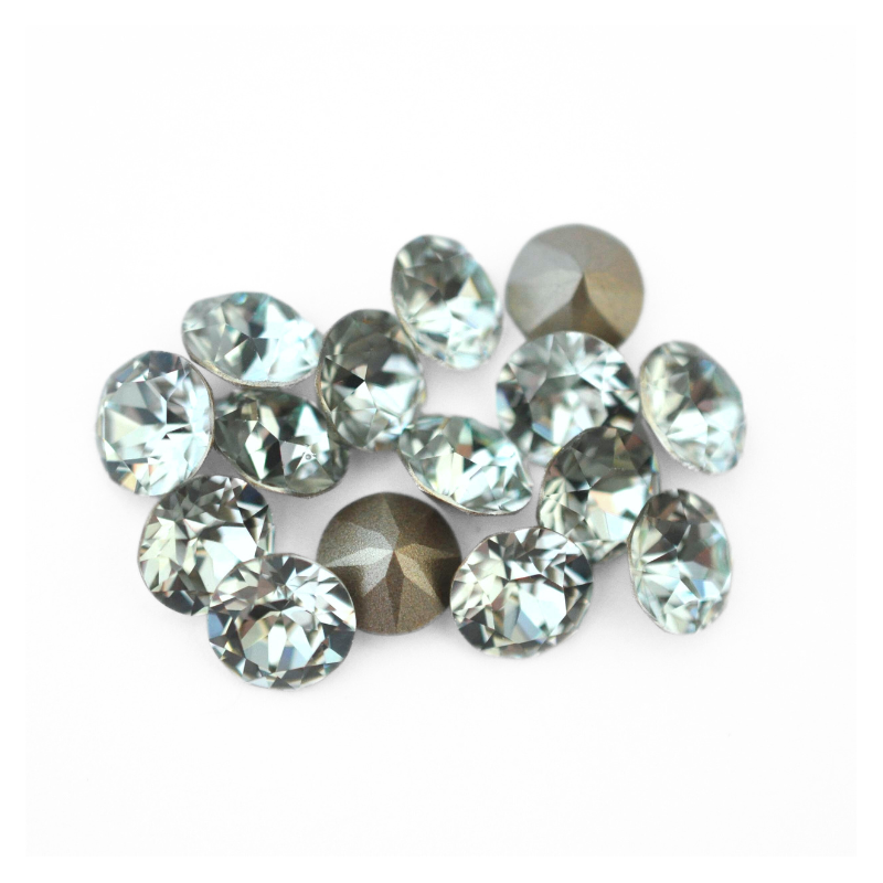 Round faceted Austrian crystal rhinestones in the color Light Azore displayed on a white background