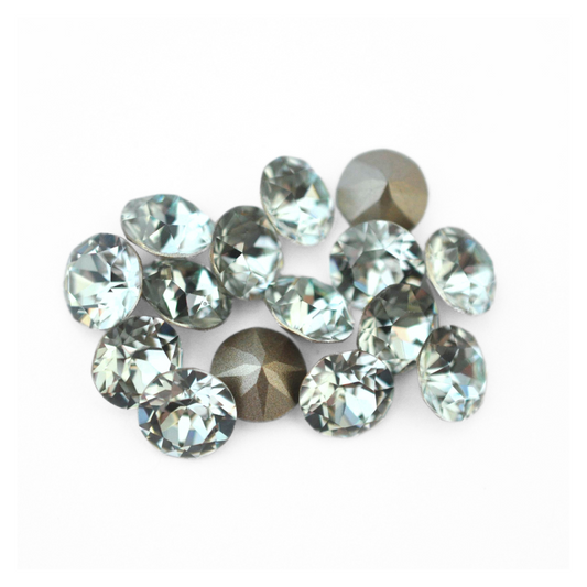 Round faceted Austrian crystal rhinestones in the color Light Azore displayed on a white background