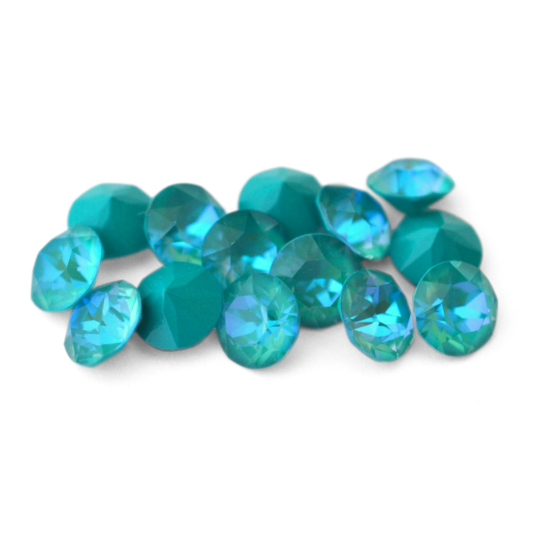 Round faceted Austrian crystal rhinestones in the color Laguna Delite displayed on a white background.
