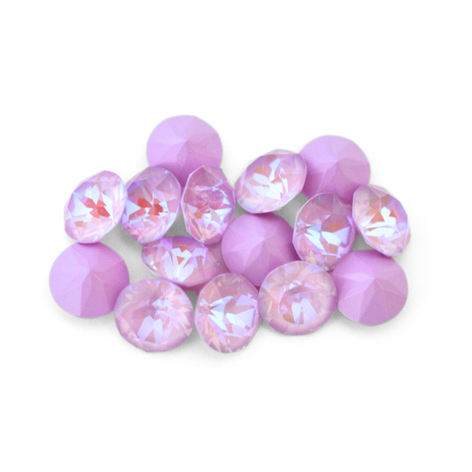 Round faceted Austrian crystal rhinestones in the color Lavender Delite displayed on a white background.