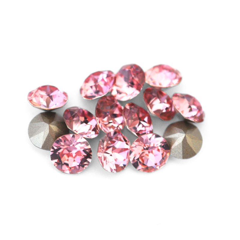 Round faceted Austrian crystal rhinestones in the color Light Rose displayed on a white background.