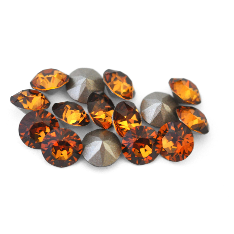 Round faceted Austrian crystal rhinestones in the color Light Amber displayed on a white background.