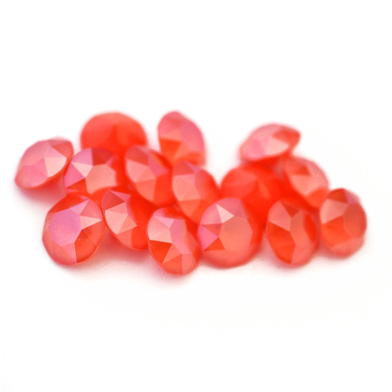 Round faceted Austrian crystal rhinestones in the color Light Coral displayed on a white background.