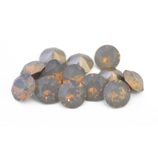 Round faceted Austrian crystal rhinestones in the color Light Grey Opal displayed on a white background.