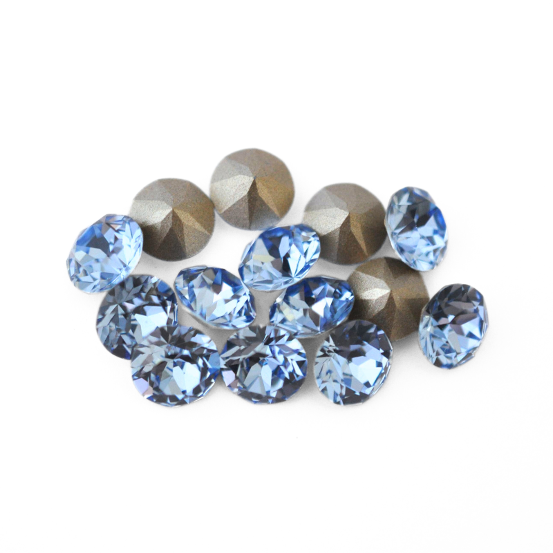 Round faceted Austrian crystal rhinestones in the color Light Sapphire displayed on a white background.