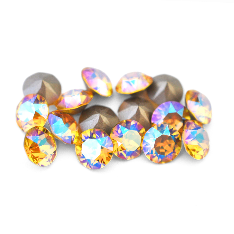 Round faceted Austrian crystal rhinestones in the color Light Topaz Shimmer displayed on a white background.