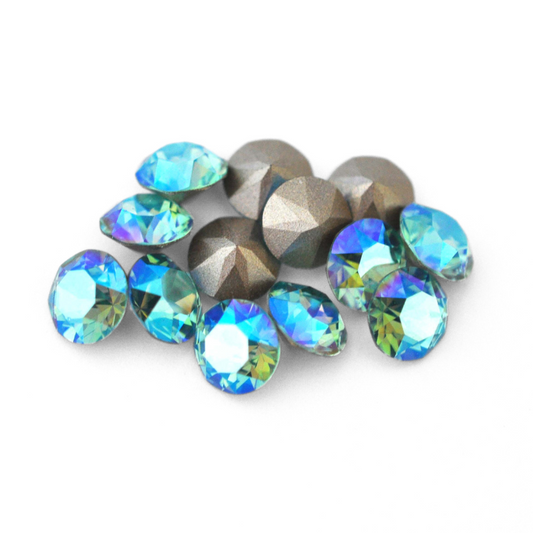 Round faceted Austrian crystal rhinestones in the color Light Turquoise Shimmer displayed on a white background