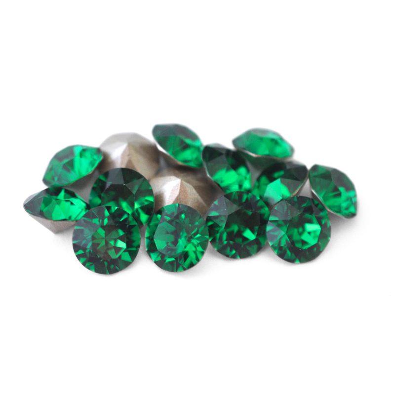 Round faceted Austrian crystal rhinestones in the color Majestic Green displayed on a white background.