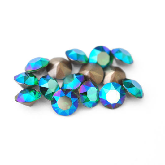 Round faceted Austrian crystal rhinestones in the color Majestic Green Shimmer displayed on a white background.