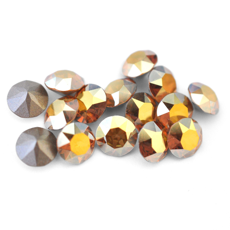 Round faceted Austrian crystal rhinestones in the color Metallic Sunshine displayed on a white background.