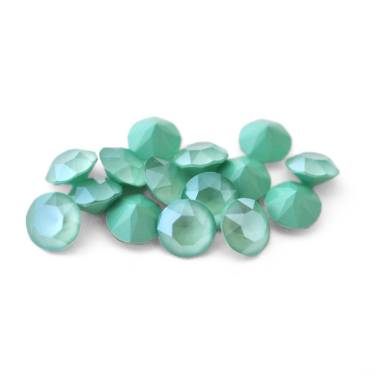 Round faceted Austrian crystal rhinestones in the color Mint Green displayed on a white background.