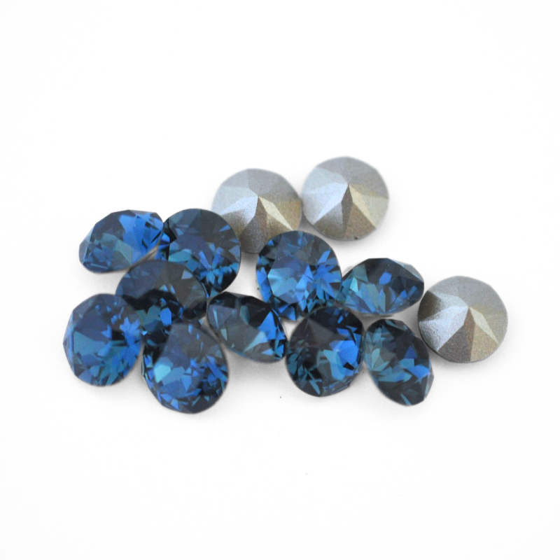 Round faceted Austrian crystal rhinestones in the color Montana displayed on a white background.
